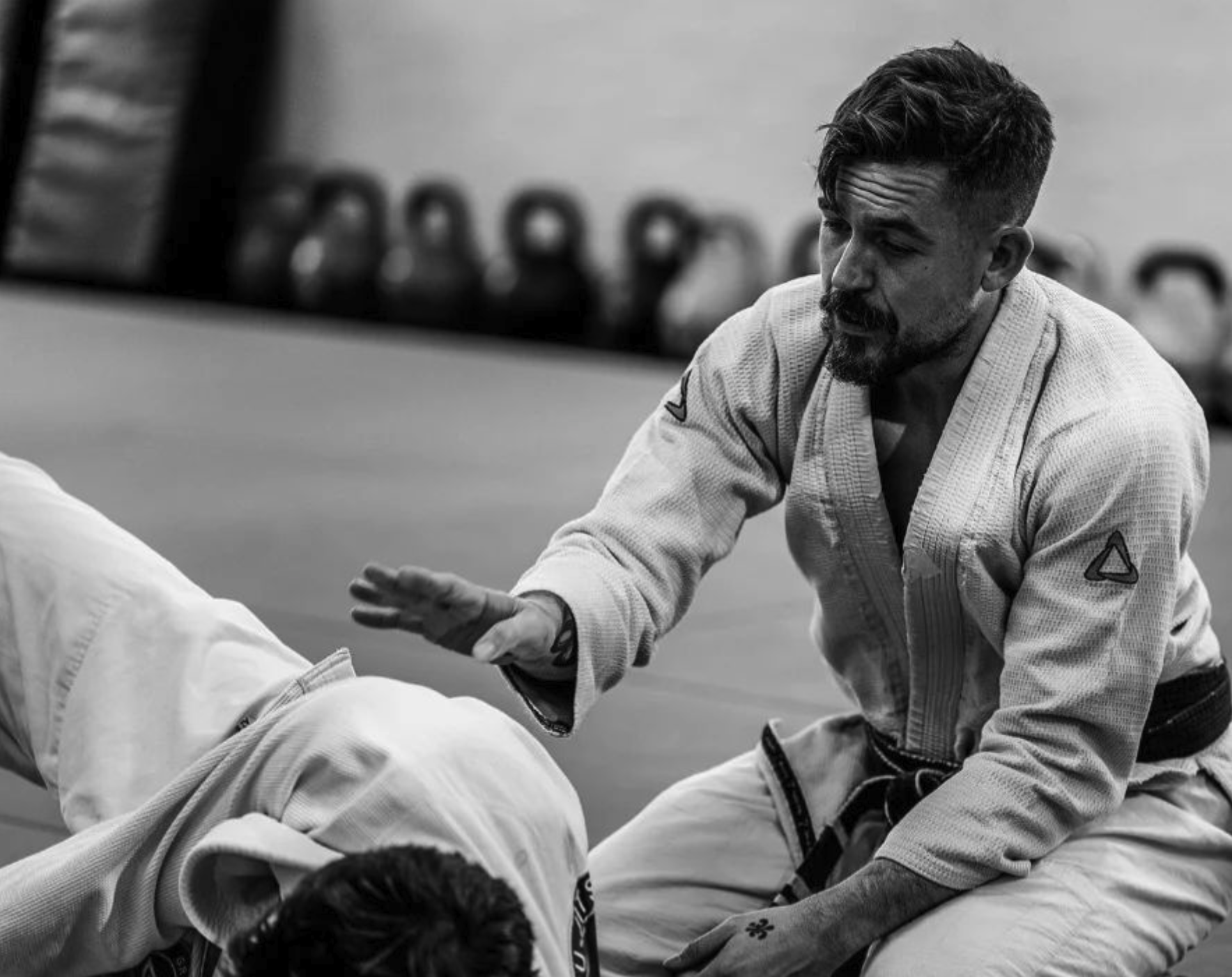 Chris Burns teaching Jiu-Jitsu on the mat